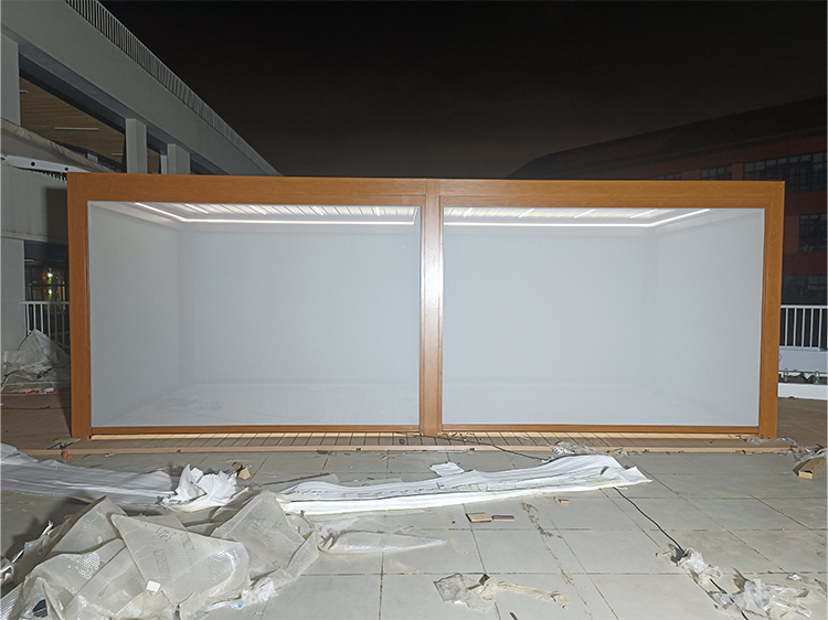Retractable windproof roller blind fully extended on wood grain aluminum pergola