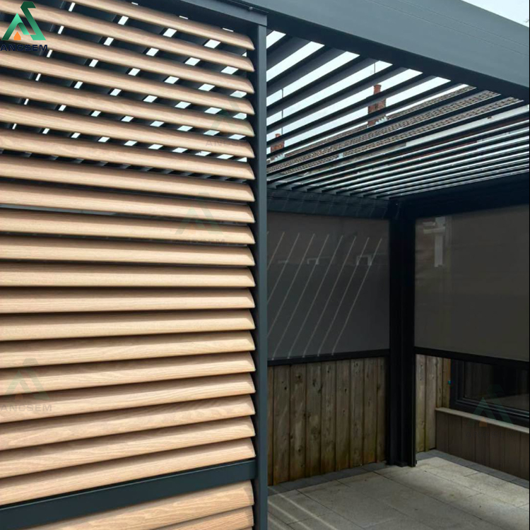 Close-up of wood-effect aluminium louvered privacy screen slats in a black frame, fitted beside a pergola with a roller blind and louvered roof